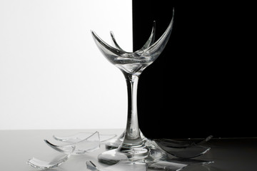 Two Broken  Glasses  with  shards of glass and shattered glass