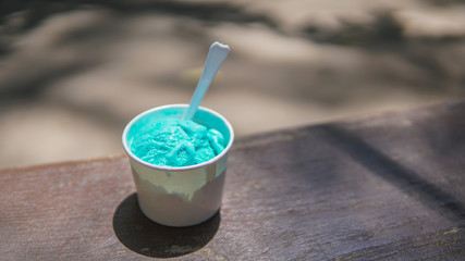 Homemade peppermint ice cream in a bowl on a wooden stand,