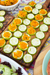 Baked roasted zucchini circles on board with carrot stuffing. Vegan lunch, vegetarian dinner, healthy food.