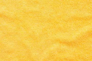 Surface of yellow microfiber cloth, macro textile pattern background