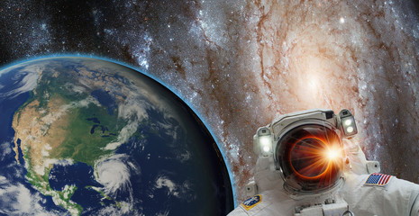 Fototapeta na wymiar An astronaut watching the Solar Eclipse in space with galaxy 