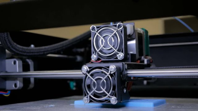 3D printing technology concept - three dimensional printing machine making physical flat 3D model at modern technology exhibition
