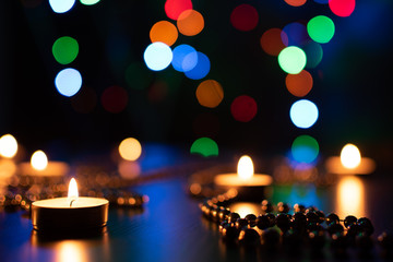 Fire of candle on christmas background. Christmas candles burning at night. Abstract candles background. Golden light of candle flame. Hope, fire. Candle lights in the darkness.