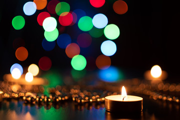 Fire of candle on christmas background. Christmas candles burning at night. Abstract candles background. Golden light of candle flame. Hope, fire. Candle lights in the darkness.