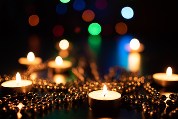Fire of candle on christmas background. Christmas candles burning at night. Abstract candles background. Golden light of candle flame. Hope, fire. Candle lights in the darkness.