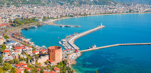 Landscape with marina and Kizil Kule tower in Alanya peninsula, Antalya district, Turkey - obrazy, fototapety, plakaty