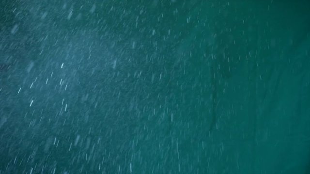 The balloon with water is broken by needle, moments broken are super slow.