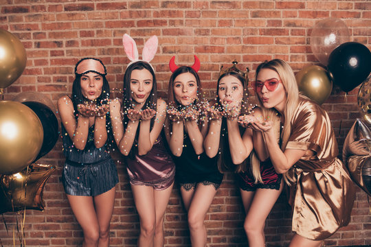 Portrait of nice company attractive sweet lovely gorgeous funny flirty cheerful positive ladies eyewear sending you kiss blowing glow glossy isolated over industrial brick wall