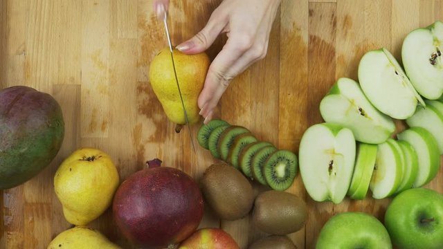 Cutting green pear on a table
