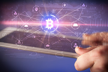 Hand using tablet with cryptocurrency bitcoin link network and online concept
