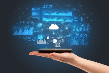 Businessman using phone with flying application icons around
