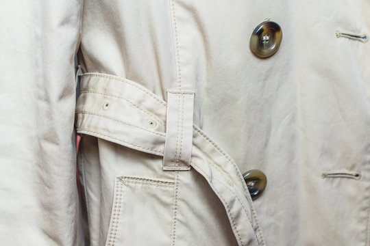 Woman trench in beige. Closeup details