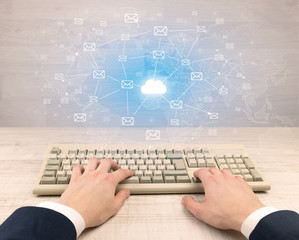 First person view of an elegant businessman hand  typing with connected mails concept
