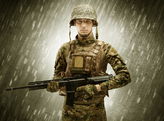 Armed soldier standing in rainy weather
