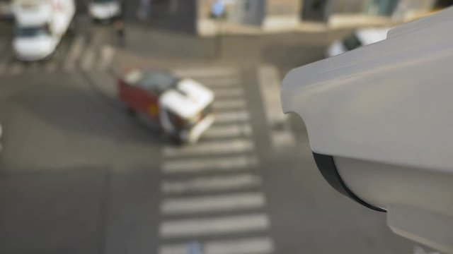 Surveillance camera with facial recognition technology on the street recording traffic flow and pedestrians. First Person View footage