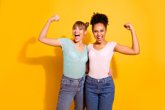 Portrait cute hipsters youth millennial raise fist scream yes yeah ready save world bodybuilders sport strong wavy curly hairdo style stylish trendy jeans t-shirts top-knot isolated yellow background