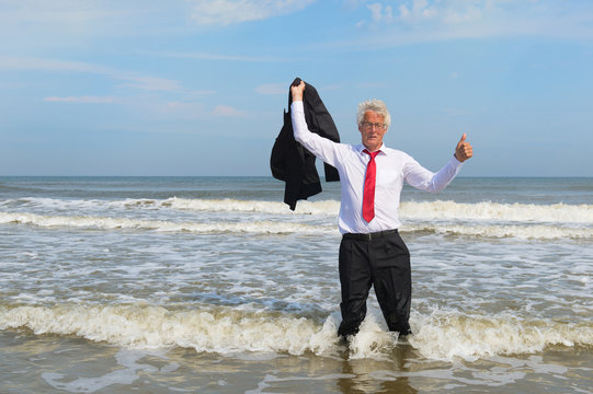 Business man standing at the beach