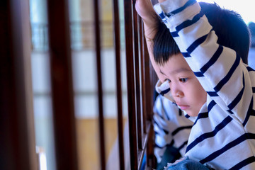 portrait of cute asian lonely young boy