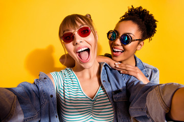 Close up photo positive cheerful content student person piggy-back laugh scream enjoy summer travel bun beautiful style stylish trendy denim wavy curly hairstyle top-knot isolated yellow background 