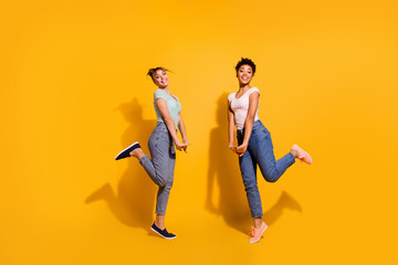 Fototapeta na wymiar Full length body size view charming millennial nice pretty teens free time weekend summer candid rest relax jeans clothes wavy curly top-knot haircut style stylish trendy isolated yellow background