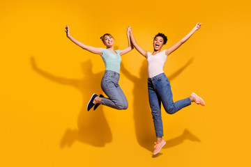Fototapeta na wymiar Full length body size view photo of positive cheerful satisfied nice student teenager hold hand free time enjoy excited trendy style stylish jeans clothes isolated wavy curly hairdo yellow background
