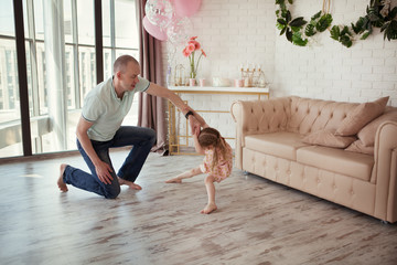 happy father and daughter at a birthday party in the house