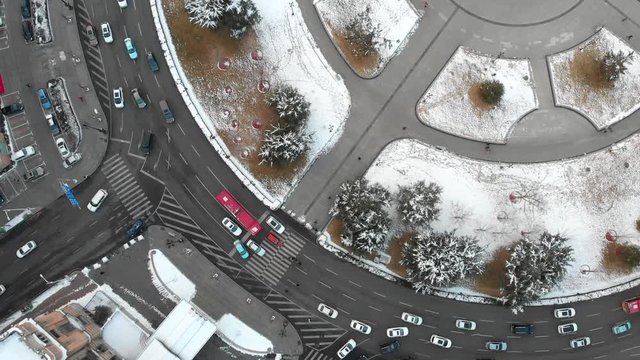 Aerial drone shot of roundabout in Dalian. Cars and traffic from above looking down during winter with snow. China.