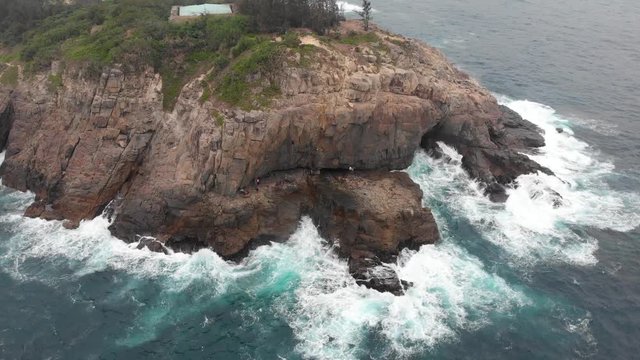Aerial shot of rocky shore of Tung Lung Island.  Popular tourist destination in Hong Kong, China. Waves crashing on the rocky beach coastline. Drone flight over the rock climbing destination. Granite.