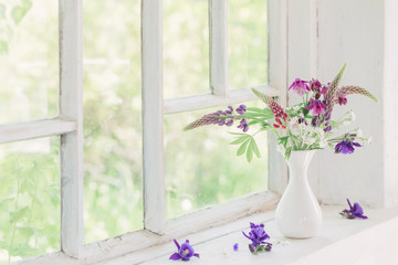 summer flowers on white windowsill