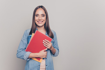 Portrait of her she nice-looking attractive lovely winsome cheerful cheery straight-haired lady holding in hands courses materials isolated over light white gray background