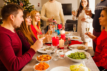 Friends around served table with drinks and meals