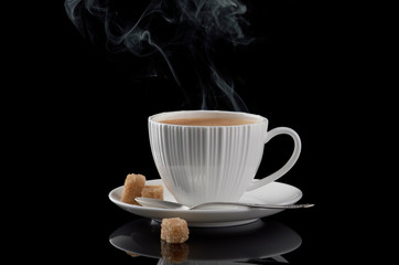 White cup with hot coffee, with cane sugar and a spoon - on a black background. - 269507016