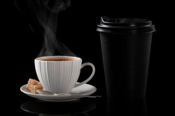White cup of coffee and black paper cup for hot drinks on a black background. - 269507076