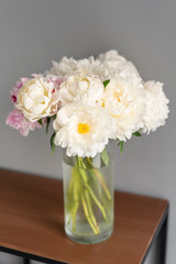 White peonies in a metal vase. Beautiful peony flower for catalog or online store. Floral shop concept . Beautiful fresh cut bouquet. Flowers delivery