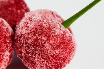 Macro shooting of frozen cherry berries covered with ice crystals