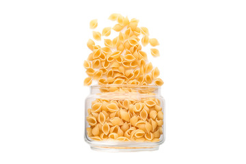 Pasta in glass jar isolated on white background. Uncooked whole wheat pasta
