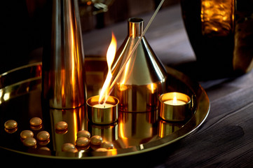 Hand lights a candle with a long match with a bright flame.The warm Golden gamma. Evening comfort....