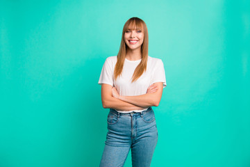 Portrait of attractive nice cute elegant lady millennial feel relaxed  want be future leader expert enjoy free time rest weekend holidays isolated wear t-shirt jeans fringe over turquoise background 