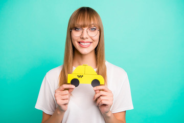 Close up photo beautiful she her lady arms hands paper yellow taxi car advising use user best speed fast service call us catch wear specs casual white t-shirt isolated teal green background