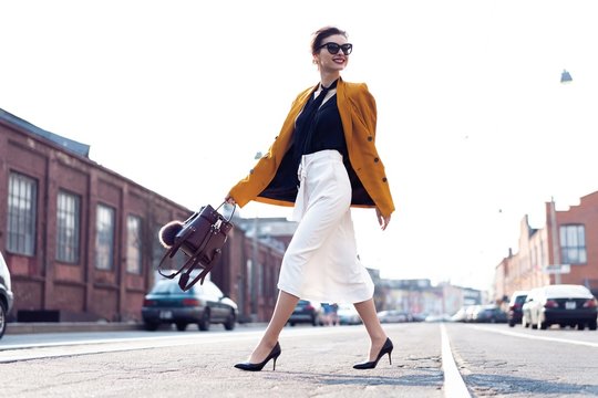 Happy Young Business Woman Walking On The Street.