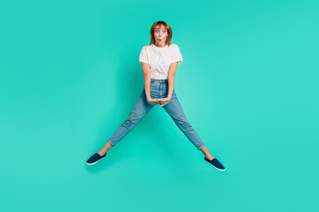 Fototapeta na wymiar Full length body size photo beautiful she her lady carefree childish weekend vacation jump high arms hands together achievement wear casual jeans denim white t-shirt isolated teal background