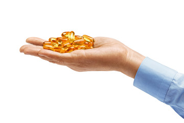 Man's hand in shirt holds many capsules Omega 3 isolated on white background. Close up. High resolution product. Health care concept