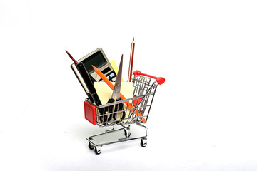 Shopping cart full with education goods for study om white background