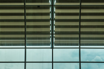 glass office building facade with big blinds