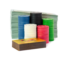 A stack of chips stay isolated on whitte background with stack of dollars and gold cards