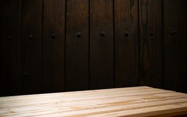 Selected focus empty brown wooden table and wall texture or old black brick wall blur background image. for your photomontage or product display