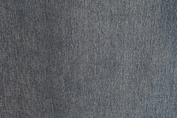 Fototapeta na wymiar Gray blue denim texture. Dark jeans close-up.