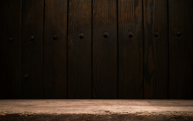 Selected focus empty brown wooden table and wall texture or old black brick wall blur background image. for your photomontage or product display