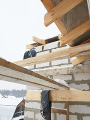 close-up view of corner of house with scaffolding, where preparatory work is carried out before...