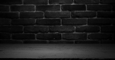 Old wooden table with brick background dark